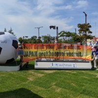 Hirokazu Tsunoda (left) holds up a Dutch-language banner along with Rifu mayor Yutaka Kumagai on Wednesday outside Miyagi Stadium. | COURTESY OF HIROKAZU TSUNODA
