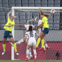 Sweden, in yellow, scores a goal against the United States during their Group G soccer match at the postponed 2020 Tokyo Olympics in Tokyo on Wednesday. Of the nearly 11,000 athletes arriving in Tokyo, 49% will be women, according to the International Olympic Committee. | ALEXANDRA GARCIA / THE NEW YORK TIMES