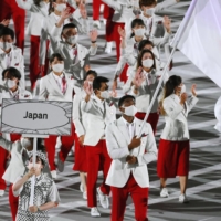 Team Japan enters the stadium, lead by basketball star Rui Hachimura. | KYODO