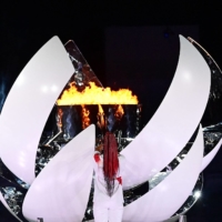 Tennis start Naomi Osaka lights the flame of hope in the Olympic Cauldron during the opening ceremony. | AFP-JIJI