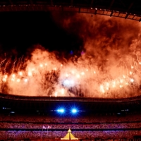 Fireworks go off around the Japan Natonal Stadium after the lighting of the Olympic flame. | AFP-JIJI