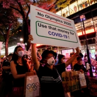 Protesters make themselves hear outside the Japan National Stadium.  | REUTERS