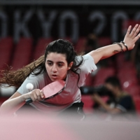 Syria\'s Hend Zaza, 12, hits a shot against Austria\'s Liu Jia during their women\'s singles preliminary round table tennis match at the Tokyo Metropolitan Gymnasium during the 2020 Tokyo Olympics on Saturday. | AFP-JIJI