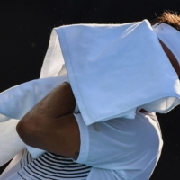 Italy\'s Fabio Fognini wipes his face with a towel during his first-round match with Japan\'s Yuichi Sugita on Saturday in Tokyo.  | AFP-JIJI
