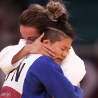 Funa Tonaki of Japan hugs Distria Krasniqi of Kosovo after their judo match | REUTERS