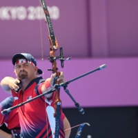 Team USA\'s Brady Ellison competes in the mixed team eliminations at Yumenoshima Park Archery Field in Tokyo on Saturday. | AFP-JIJI
