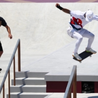Skateboarding legend Tony Hawk films Nyjah Huston of the United States during training for the Tokyo Olympics at Ariake Urban Sports Park in the capital on Saturday.  | REUTERS