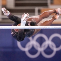 Simone Biles practices on the uneven bars at Ariake Gymnastics Center in Tokyo on July 22. | CHANG W. LEE / THE NEW YORK TIMES