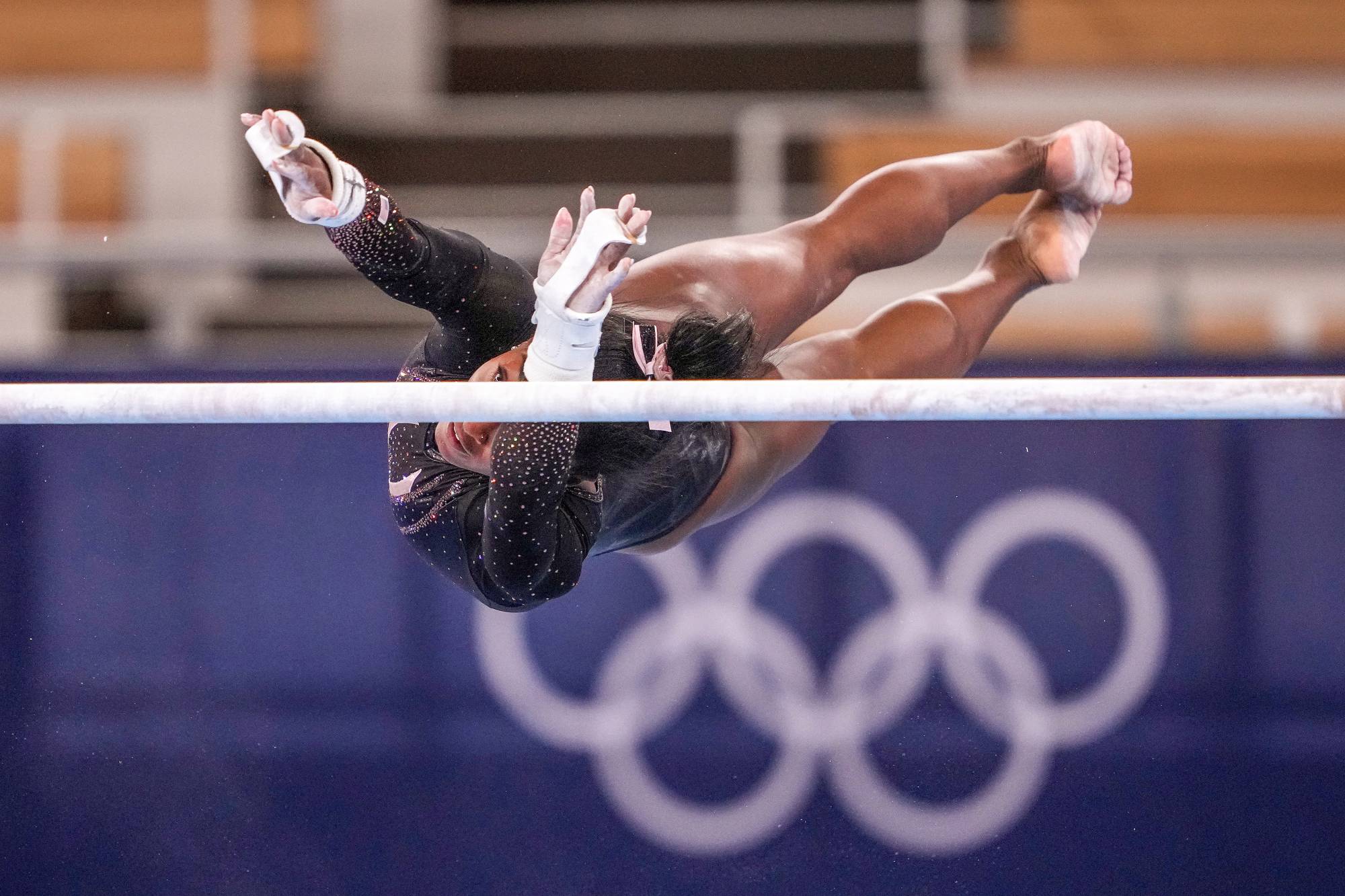 Simone Biles practices on the uneven bars at Ariake Gymnastics Center in Tokyo on July 22. | Chang W. Lee / The New York Times