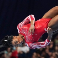 Simone Biles competes during the floor exercise at the U.S. Olympic women’s gymnastics trials in St. Louis in June, where she earned a spot on her second Olympic team.  | CHANG W. LEE / THE NEW YORK TIMES