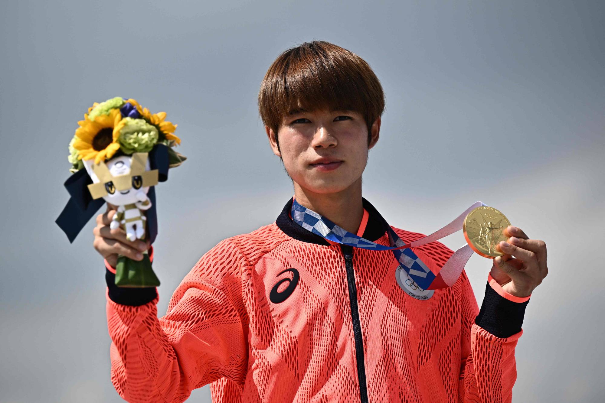 Japan's Yuto Horigome poses on the podium after becoming skateboarding's first Olympic gold medalist. | AFP-JIJI