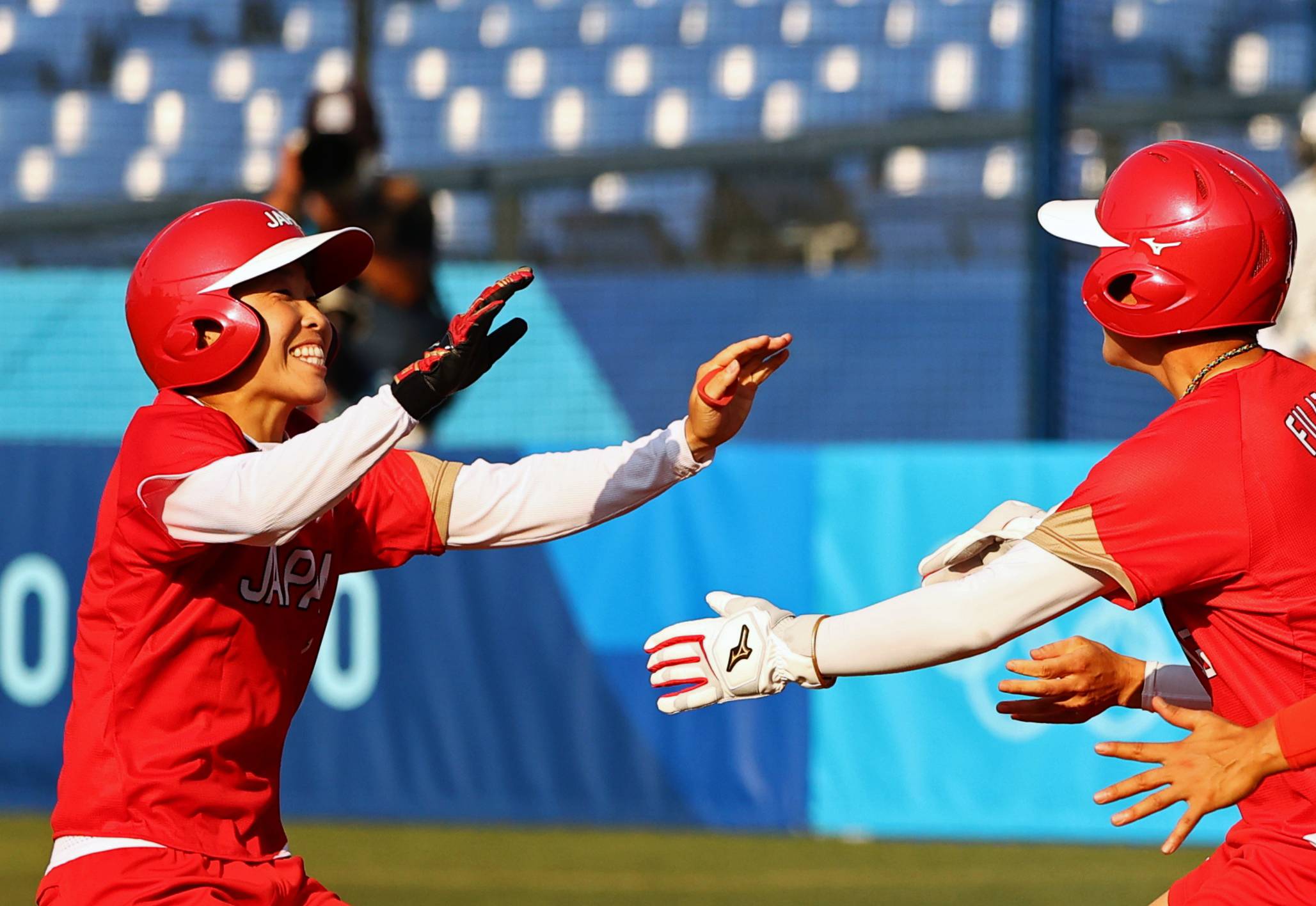 Yamato Fujita of Japan celebrates with teammates. Japan booked its spot in the gold medal game against the U.S. with a 1-0 win over Canada. | REUTERS