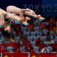 China\'s She Tingmao and Wang Han in action at the women\'s 3 meter springboard synchro | REUTERS