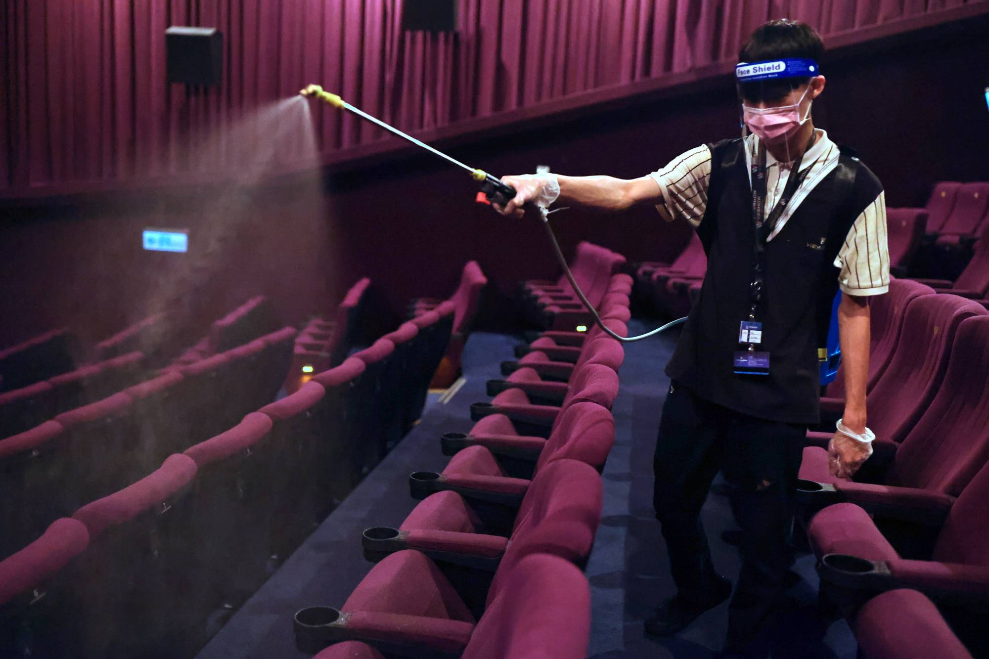 Disinfection work at a cinema in Taipei ahead of eased COVID-19 restrictions | Reuters 