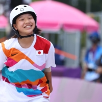 Momiji Nishiya of Japan smiles after one of her tricks in the women\'s street skateboarding competition in Tokyo on Monday.  | REUTERS