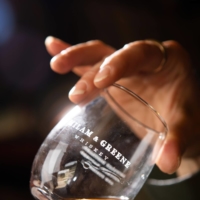 Heather Greene, one of the founders, holds a glass at the Milam & Greene distillery in Blanco, Texas, in May 2021. In just the few years since its founding, Milam & Greene has become one of the most highly regarded distilleries in Texas. | JESSICA ATTIE / THE NEW YORK TIMES