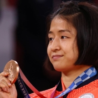 Fighting in her first Olympics, Tsukasa Yoshida earned a victory in the bronze-medal match over Eteri Liparteliani of Georgia.  | REUTERS