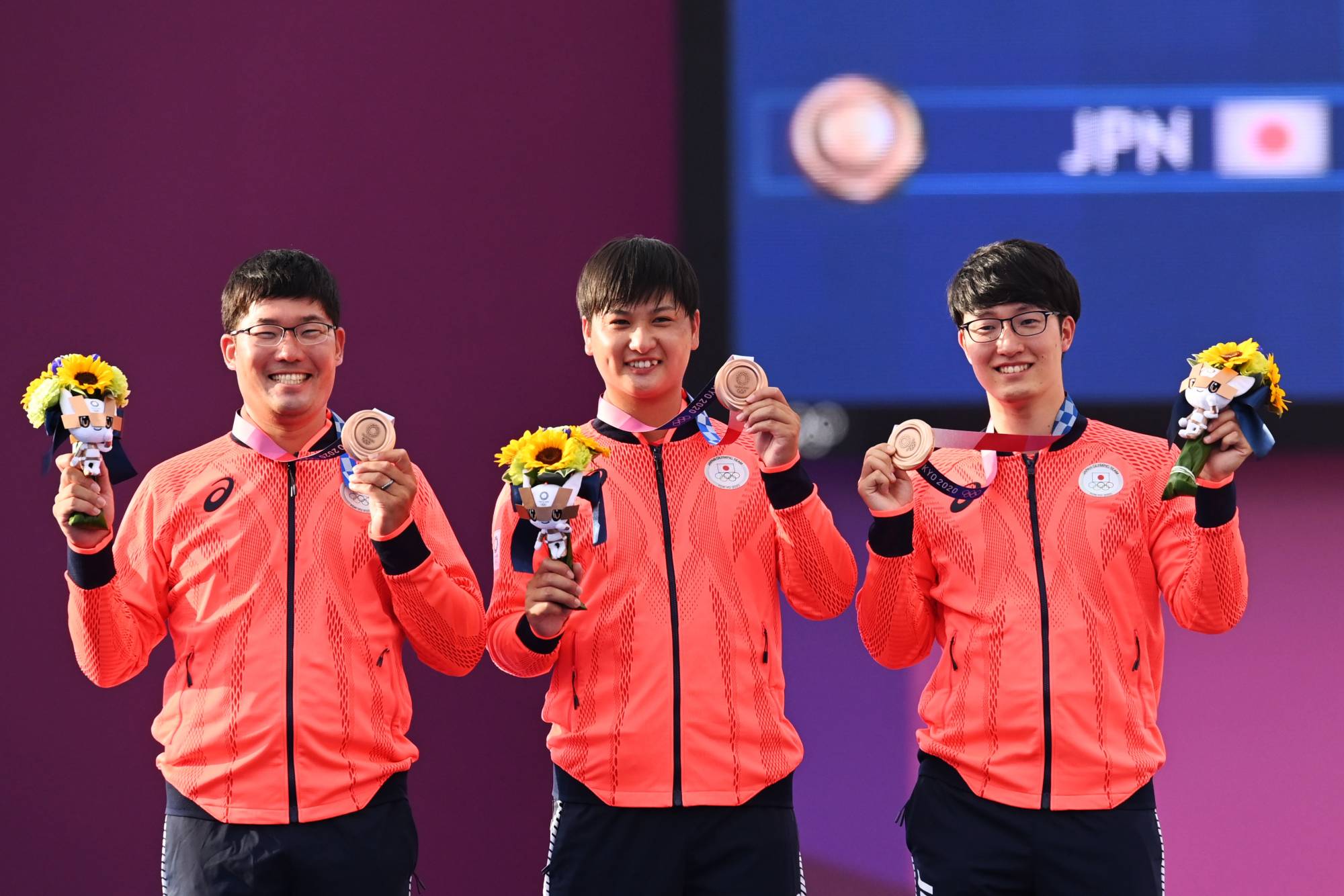 Takaharu Furukawa, Yuki Kawata and Hiroki Muto celebrate their bronze medals on the podium on Monday. | REUTERS