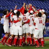 The Japanese women\'s team celebrates their win over the U.S. during the Tokyo Olympic softball gold medal game in Yokohama on Tuesday. | REUTERS