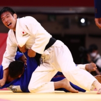 Takanori Nagase of Japan reacts after winning gold against Saeid Mollaei of Mongolia on Tuesday at Nippon Budokan.  | REUTERS