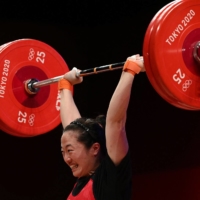 Japan\'s Mikiko Andoh competes in the women\'s 59-kg Olympic weightlifting competition in Tokyo on Tuesday.  | AFP-JIJI