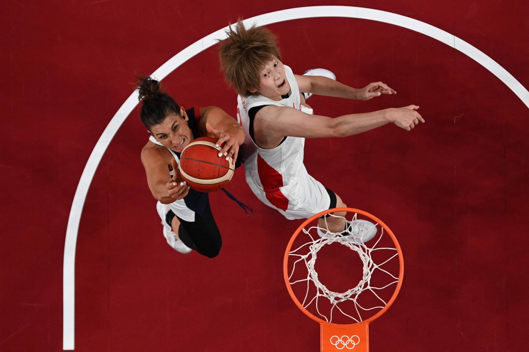 France's Helena Ciak (left) goes to the basket as Japan's Maki Takada defends during Group B action at Saitama Super Arena on Tuesday. Pool / Via AFP-JIJI | POOL / VIA AFP-JIJI