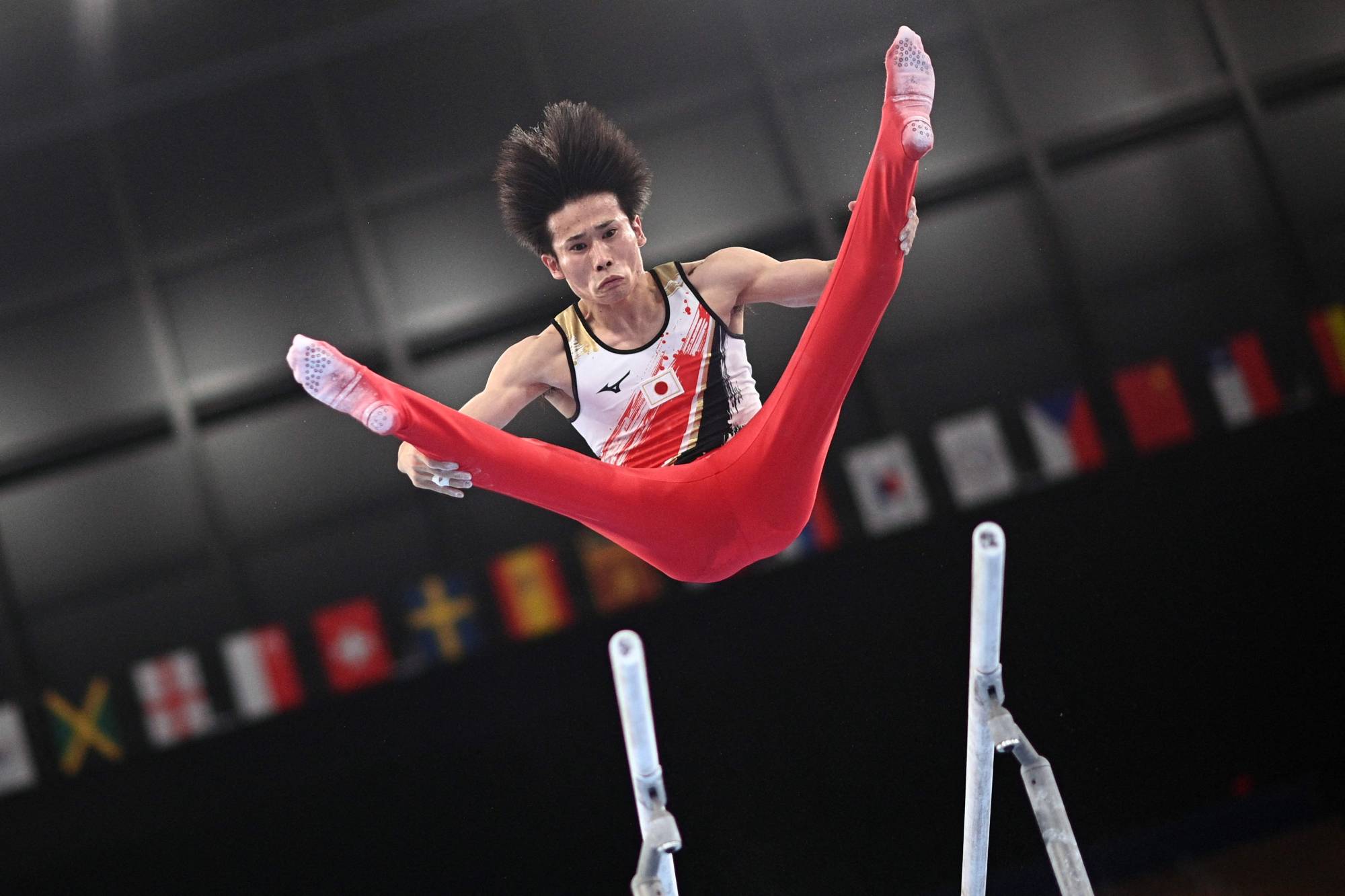 Japan's Kazuma Kaya competes in the parallel bars event of the artistic gymnastics men's team final | AFP-JIJI