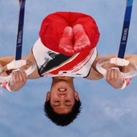 Daiki Hashimoto of Japan performs on the rings during the men\'s team final at Ariake Gymnastics Centre on Monday.  | REUTERS