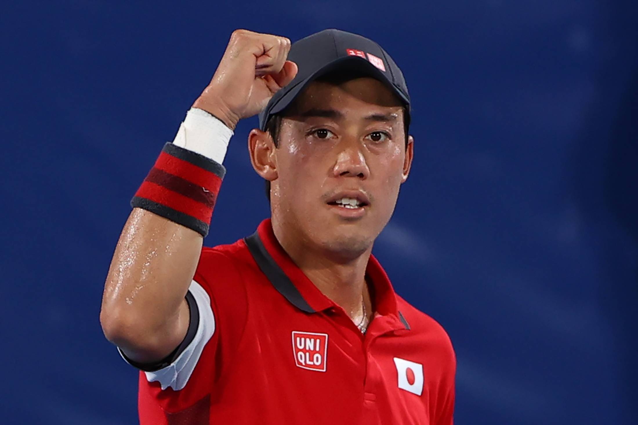 Kei Nishikori celebrates after winning his second-round match on Tuesday at Ariake Tennis Park. | reuters