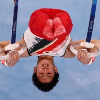 Daiki Hashimoto of Japan performs on the rings during the men\'s team final at Ariake Gymnastics Centre on Monday.  | REUTERS