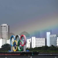 A rainbow is seen above the Olympic rings near Odaiba Marine Park during the women\'s individual triathlon competition. | AFP-JIJI