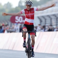 Anna Kiesenhofer of Austria celebrates winning gold in the woen\'s road race on Sunday.  | POOL / VIA REUTERS