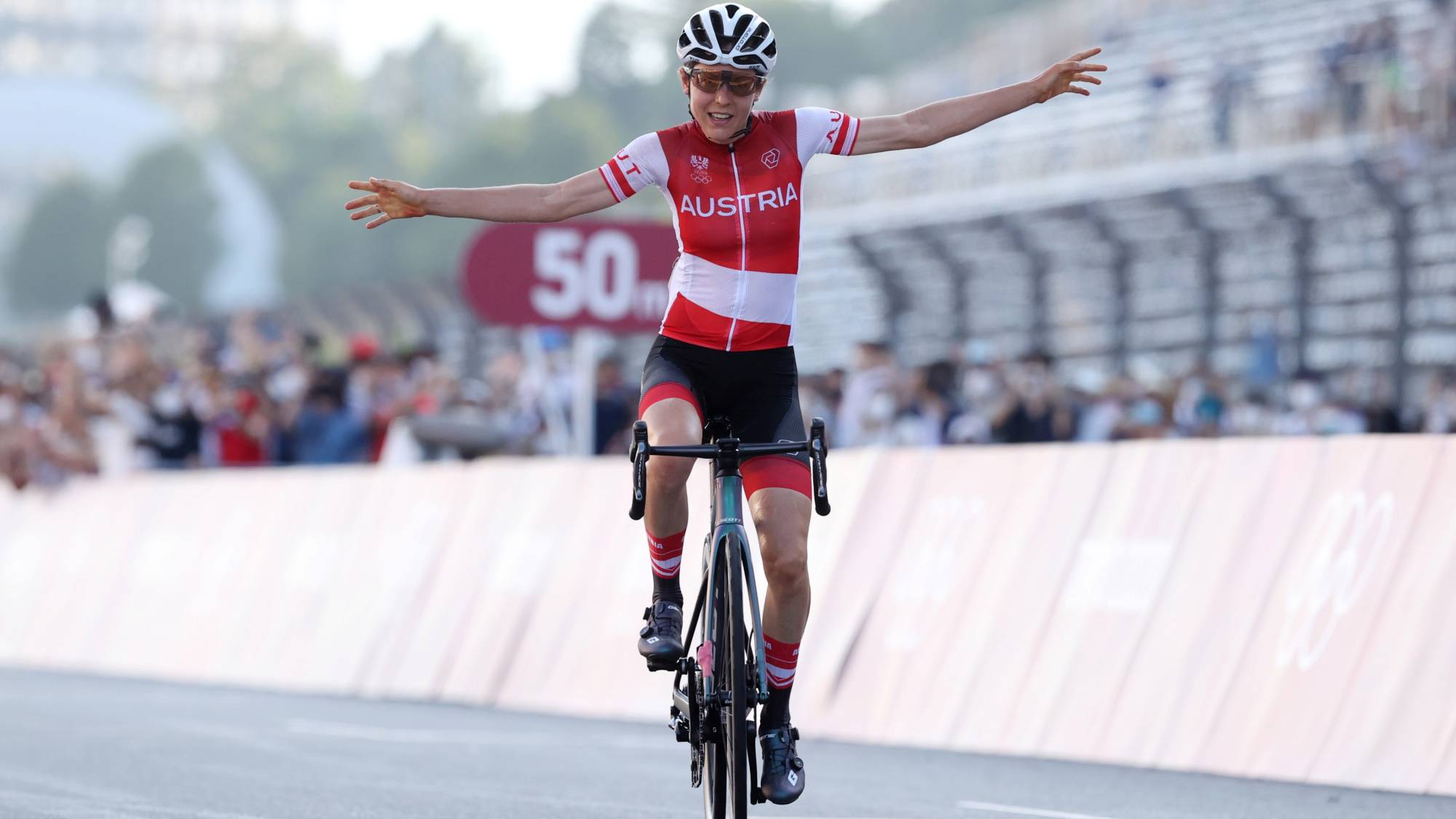 Anna Kiesenhofer of Austria celebrates winning gold in the woen's road race on Sunday.  | POOL / VIA REUTERS