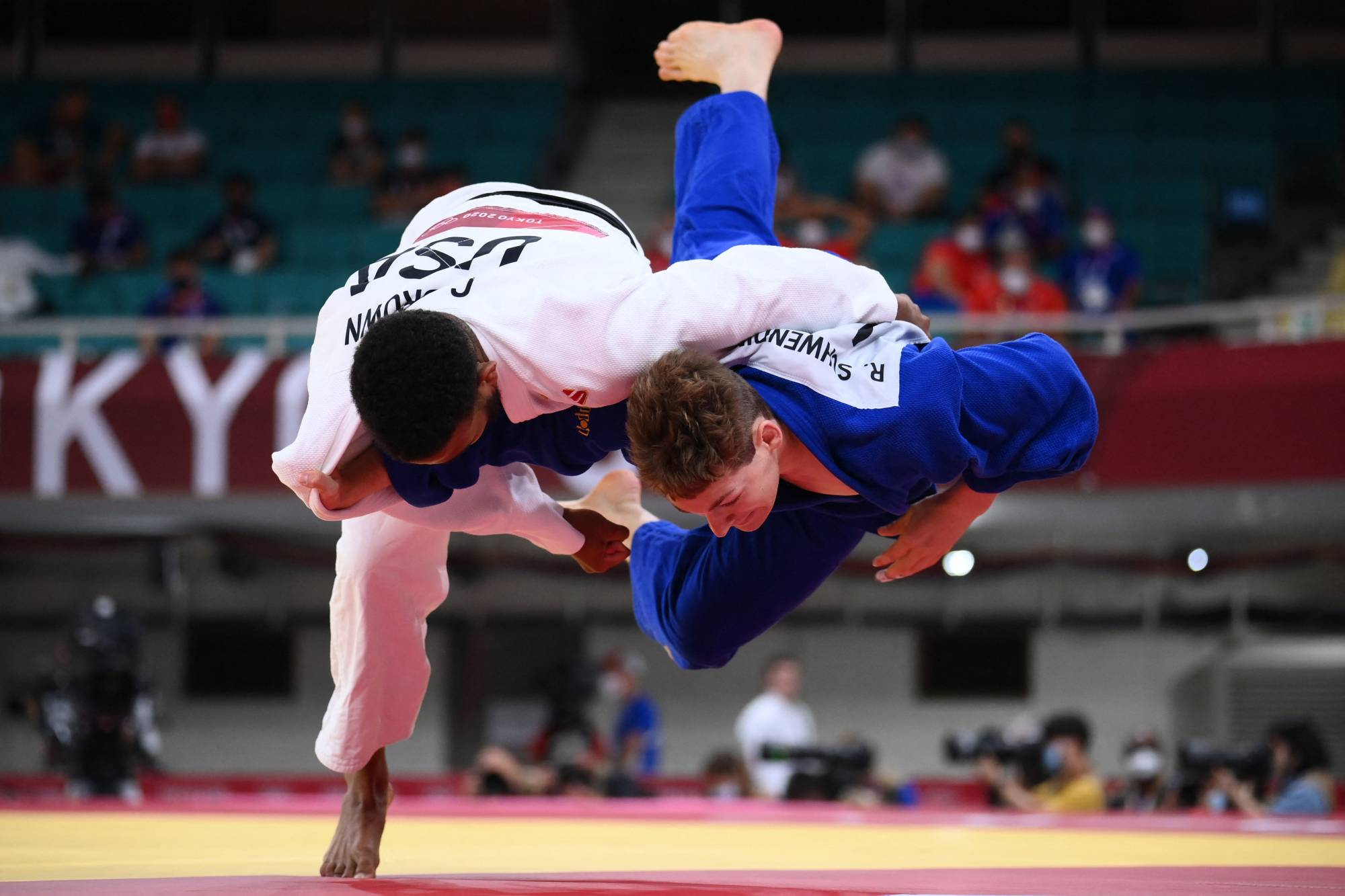 USA's Colton Brown (white) and Liechtenstein's Raphael Schwendinger compete in the judo men's -90kg elimination round bout at the Nippon Budokan. | AFP-JIJI