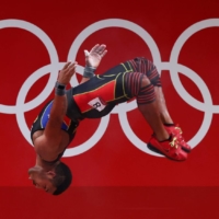 Julio Mayora of Venezuela celebrates during the men\'s 73-kg weightlifting. Mayora won the silver medal. |  REUTERS