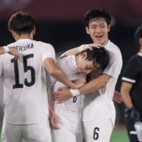Japan\'s Koji Miyoshi and Wataru Endo celebrate during the France vs Japan soccer match in Yokohama. | REUTERS