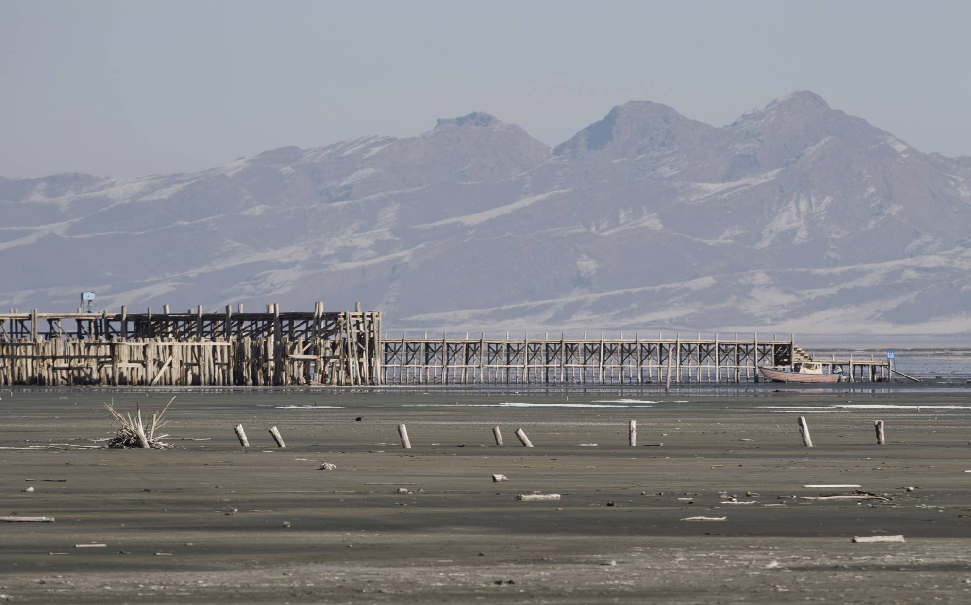 A boat lies docked next to an abandoned pier on Lake Urmia. | Morteza Nikoubazl / The New York Times 