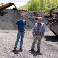 Troy Mullins, 20, and his father, Cosam Mullins, 68, at an Abandoned Mine Land reclamation site where they both operate heavy equipment in Clinchco, Virginia. | REUTERS