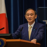 Prime Minister Yoshihide Suga speaks during a news conference in Tokyo on July 8. | BLOOMBERG