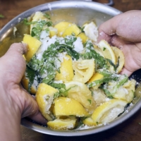 Add the lemon rind and shiso leaves to a bowl. Pour in the sugar, and mix with your hands or a large spoon for maximum coverage. | ALEX FISHER
