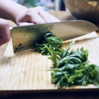Roll the shiso leaves together and finely slice them into thin strips. | ALEX FISHER
