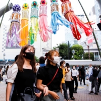 People at the Shibuya crossing in Tokyo on Thursday | REUTERS
