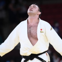 Japan\'s Aaron Wolf celebrates winning the judo men\'s under 100-kg gold medal bout on Thursday at Tokyo\'s Nippon Budokan. | AFP-JIJI
