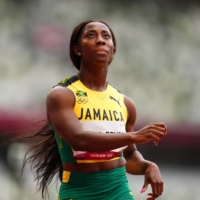 Sprinter Shelly-Ann Fraser-Pryce of Jamaica finishes first in her 100-meter heat | REUTERS