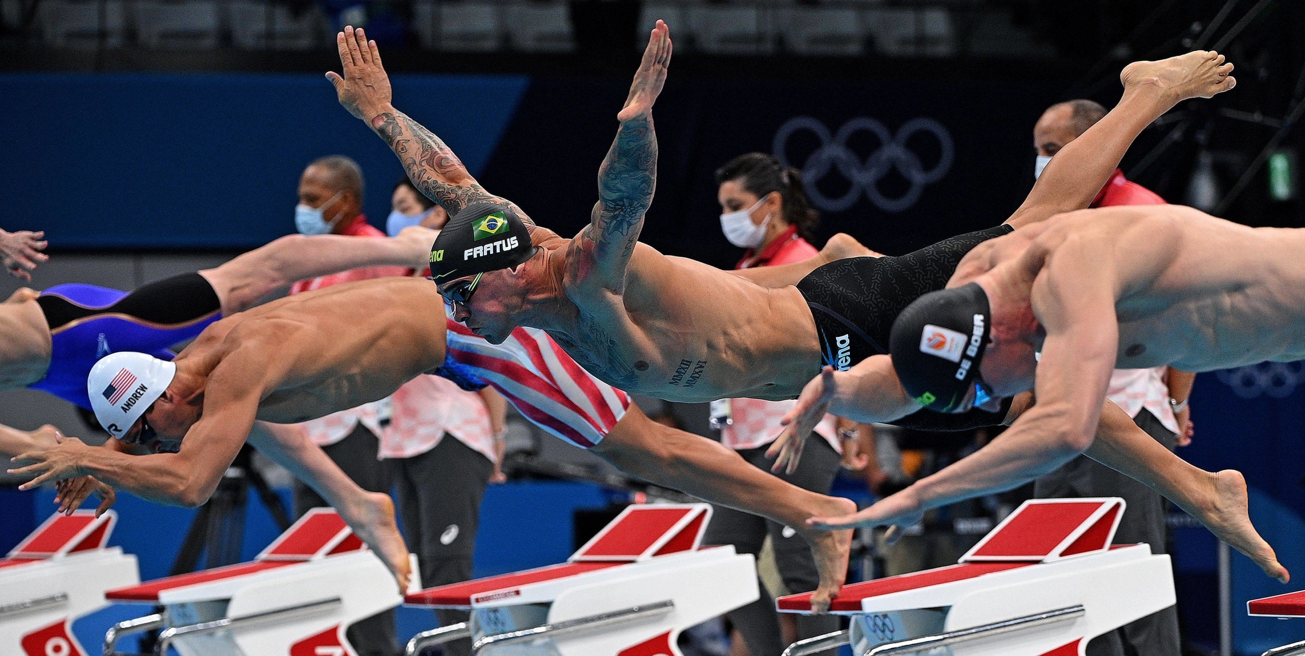 Swimmers dive in at the start of a heat for the men's 50-meter freestyle swimming event | AFP-JIJI