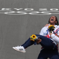 British BMX racers Kye Whyte and Bethany Shriever celebrate after receiving their medals | REUTERS