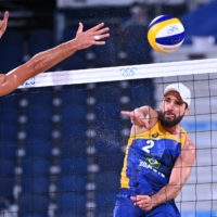 Brazil\'s Bruno Oscar Schmidt (right) spikes the ball as Poland\'s Michal Bryl defends in the men\'s preliminary beach volleyball pool match. | AFP-JIJI