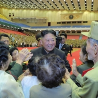 North Korean leader Kim Jong Un takes part in a photo session in Pyongyang on Thursday. | KCNA / KNS / VIA AFP-JIJI