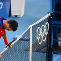 Novak Djokovic reacts after losing to Pablo Carreno Busta in the bronze medal match.  | AFP-JIJI