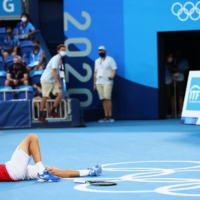 Pablo Carreno of Spain celebrates after winning his bronze medal match against Novak Djokovic of Serbia on Saturday at Ariake Tennis Park.  | REUTERS